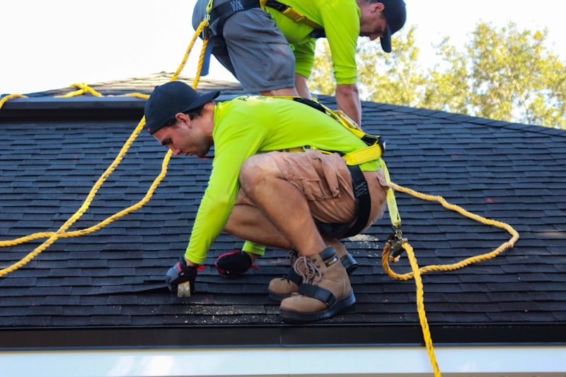 Crew installing new shingles on a Miami home
